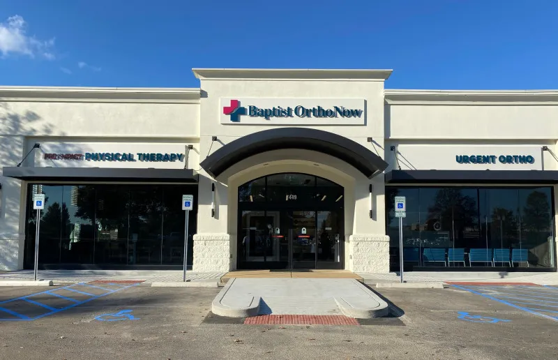 The exterior of a medical facility named "Baptist OrthoNow" features large windows, a wheelchair-accessible entrance, and signs for "Urgent Ortho" and "Physical Therapy."
