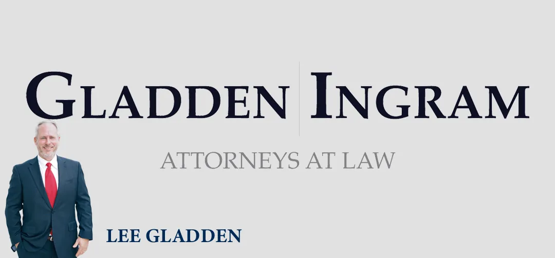 A man in a suit stands next to the text "GLADDEN | INGRAM ATTORNEYS AT LAW" and "LEE GLADDEN" displayed prominently on a light gray background.